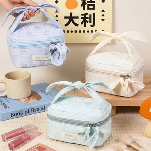 Floral print bow handle makeup bags in pastel blue, cream and mint for travel storage