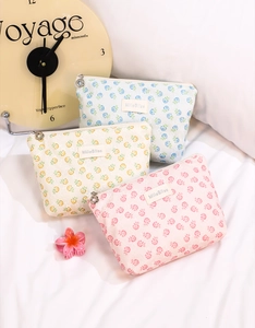 Detailed close-up of floral mesh cosmetic bags with unique flower-shaped metal zipper pull