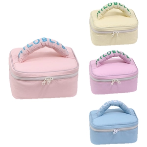 Set of four quilted macaron color makeup bags with dual zippers and carry handles