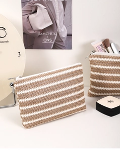 Macro shot of striped knit texture and zip closure on the cosmetic organizer set