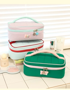 Close-up of quilted nylon cosmetic bags in pastel colors with floral zipper charms