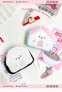 Detail of house-shaped plush storage bag with carabiner clip for keys and accessories