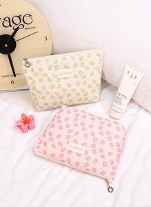 Detail of floral mesh cosmetic bags with lace texture and elegant flower zipper pulls