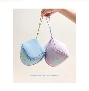 Detail of macaron blue and purple cloud makeup bags with contrast handles and soft texture