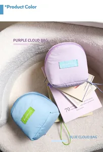 Close-up of quilted lavender and sky blue mini cloud makeup bags on soft white fabric
