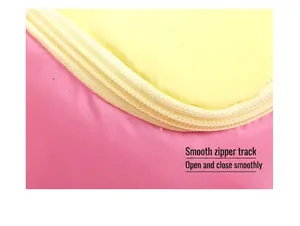 Detail of smooth nylon zipper on a pink and yellow polyester house-shaped cosmetic bag