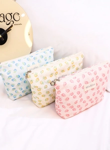 Detail of floral mesh cosmetic bags in blue, yellow and pink with 3D lace texture