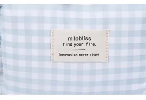 Macro view of blue checkered fabric texture with contrast woven label and neat stitching
