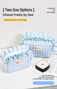 Blue and white gingham quilted makeup bag with ruffle trim and soft cotton texture