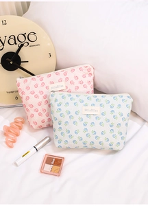 Close-up of mesh floral cosmetic bags with lace texture and elegant zipper detail