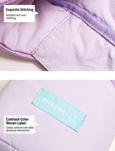 Detail of precise stitching and blue brand logo label on purple fabric cosmetic bag