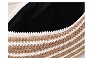 Macro detail of the woven stripe cosmetic bag showing fine stitching and white zipper