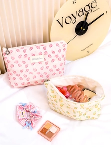 Detailed view of floral mesh makeup bags with pink rose pattern and golden zipper closure