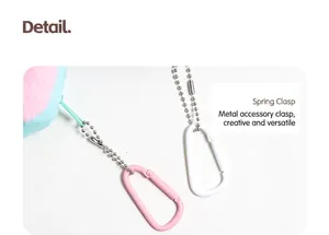 Detail shot of the durable metal carabiner clip and beaded chain on a house-shaped pouch