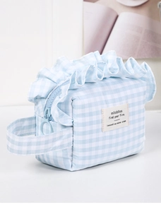 Detail of blue plaid makeup bag with ruffles and large metal zipper ring pull