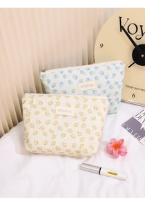 Detail of floral mesh makeup bags with MiloBliss brand label and metal zipper closures