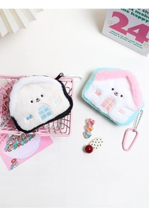 Close-up of cute plush house coin purses with detailed embroidery and metal snap hooks