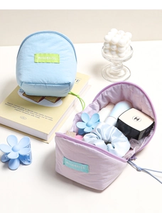 Detail view of nylon cloud-shaped cosmetic bags with top zipper and woven label