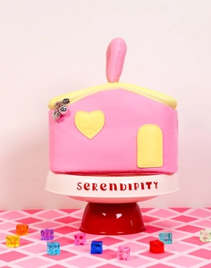 Detailed view of house-shaped makeup bag with heart zippers and a sturdy handle