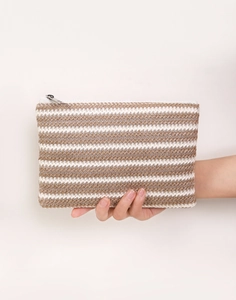 Detail of hand-held woven makeup bag with striped pattern and silver metal zipper