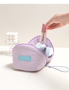 Detail showing the spacious interior of the purple cloud makeup bag with lipstick storage