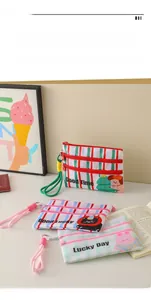 Detail of three-layer canvas zipper pouches with cute stripes and cartoon patterns