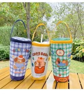 Three cute cartoon insulated cup bags with dog and capybara prints on a wooden table