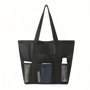 Close-up of black mesh shower bag with multiple pockets for toiletries and water bottle