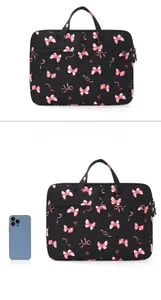 Close-up of black laptop bag with pink bows featuring sturdy handles and front pocket