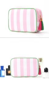 Detail showing pink striped canvas makeup bag with green trim and colorful tassel