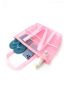 Pink mesh beach tote showing interior space with slippers and sunscreen spray detail