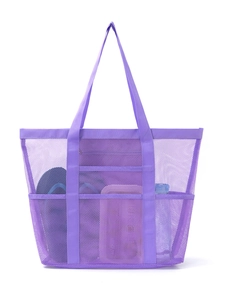 Detail of purple mesh beach tote with multiple storage pockets and wide carry handles
