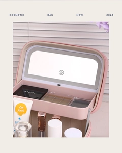 Detail view of pink leather makeup bag with integrated LED mirror and USB port