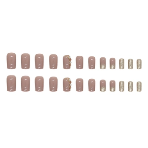 Sparkly purple square press-on nails with golden glitter and rhinestone decorations