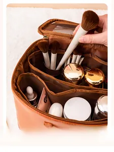 Internal view of large capacity makeup bag showing brush elastic bands and compartments
