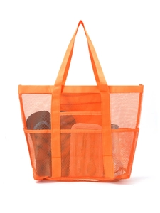 Detail of a large orange mesh beach bag with reinforced handles and front pocket storage