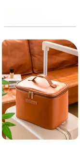 Brown faux leather makeup bag with Makeup embossing shown on a white suitcase