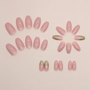Short ballet press-on nails in pale pink with sparkling gold glitter accents