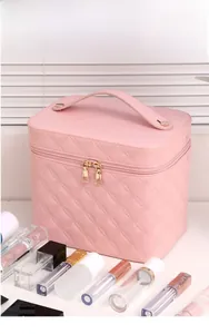 Pink quilted PU leather cosmetic bag with gold zippers and sturdy top handle