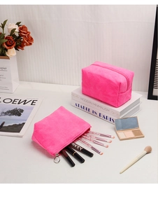 Dettaglio della borsa per cosmetici in peluche rosa con cerniera e spazio interno