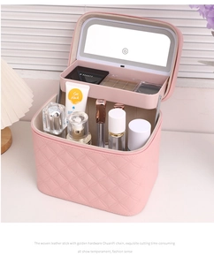 Detail of pink quilted cosmetic case with LED mirror and USB charging port interior