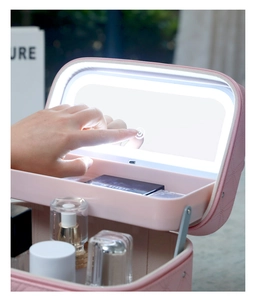 Detail of pink leather makeup case showing touch LED mirror and organized cosmetics