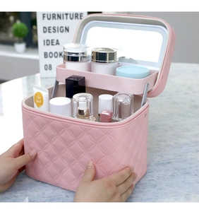 Pink quilted travel makeup case with integrated LED mirror and spacious internal tray