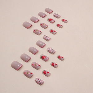 Pink French press-on nails with cute strawberry, flower, and smiley face patterns