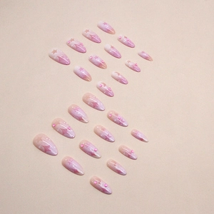 Faux ongles amande dégradé rose et violet avec motifs étoile lune évidés et strass brillants