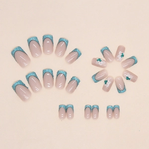 Blue French press-on nails set with glitter tips, 3D white flowers and teal gemstone accents