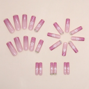 Pink gradient glitter fake nails with white floral prints and sparkling rhinestones