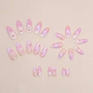 Faux ongles amande dégradé rose violet avec motifs étoiles lune et petits strass brillants