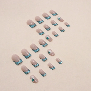 French blue glitter press-on nails with white flowers and emerald rhinestones