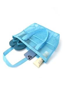 Detail view of blue mesh beach bag with multi-pocket storage and breathable polyester net